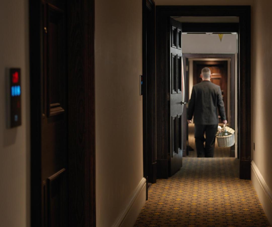 더 라리트 런던 외부 사진 A room service employee delivers room service to a guest room